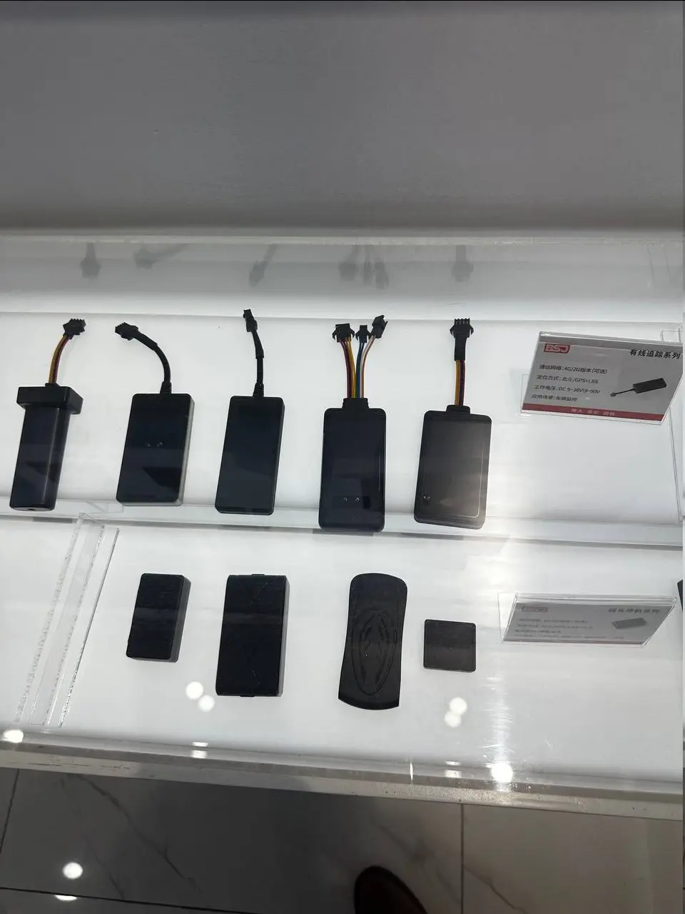 Wired and wireless vehicle tracking devices displayed in the client's showroom